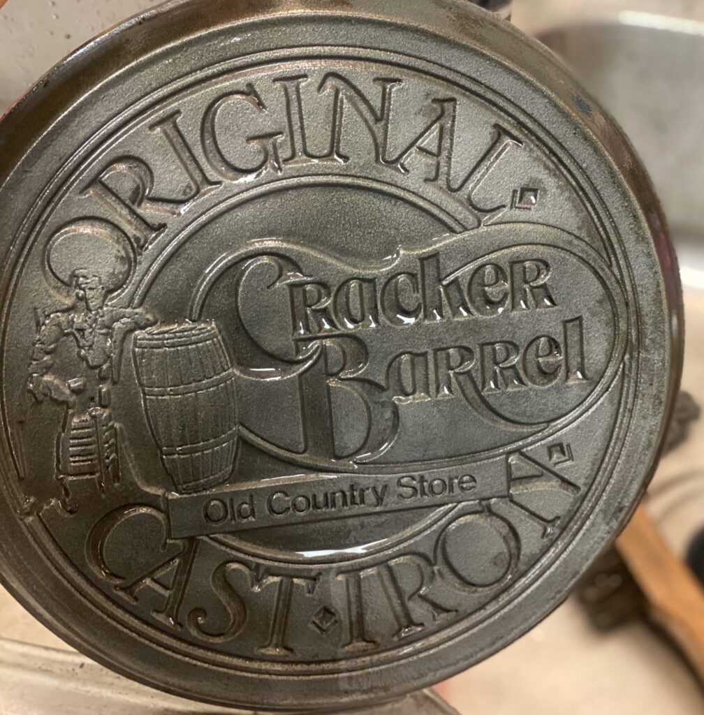 a partially seasoned vintage Cracker Barrel cast iron skillet