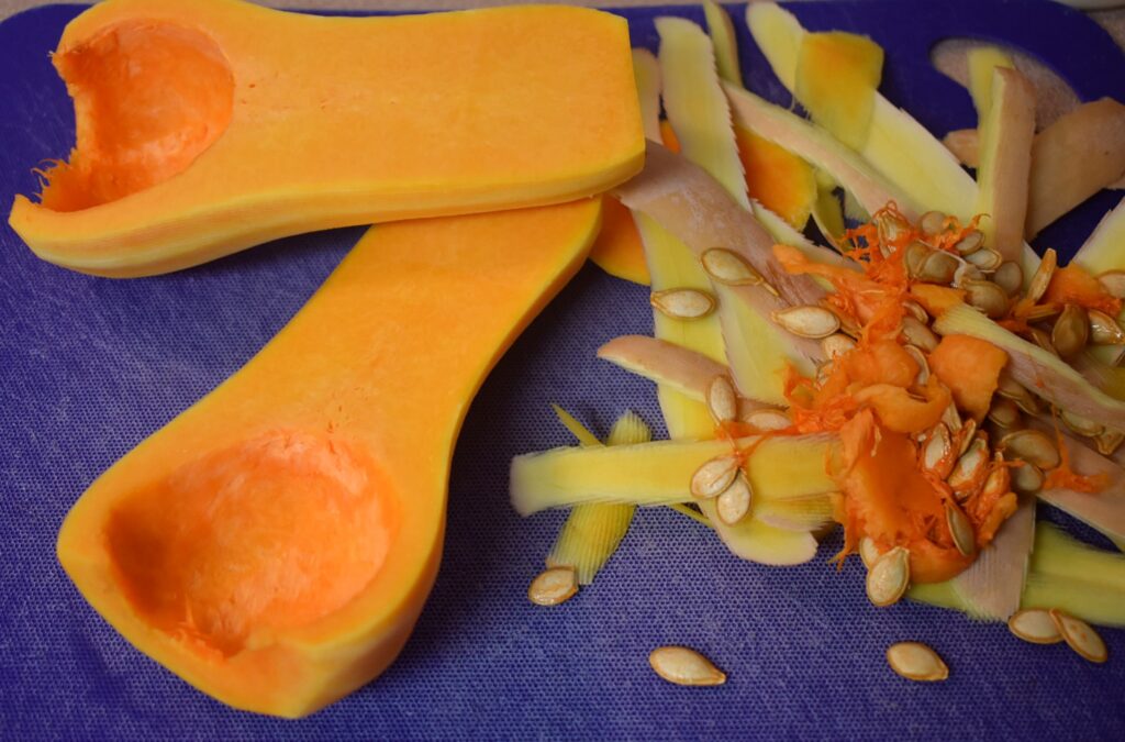 peeled and deseeded butternut squash on blue cutting board