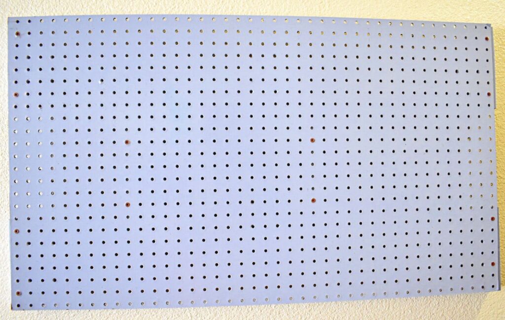 periwinkle peg board hanging on the wall