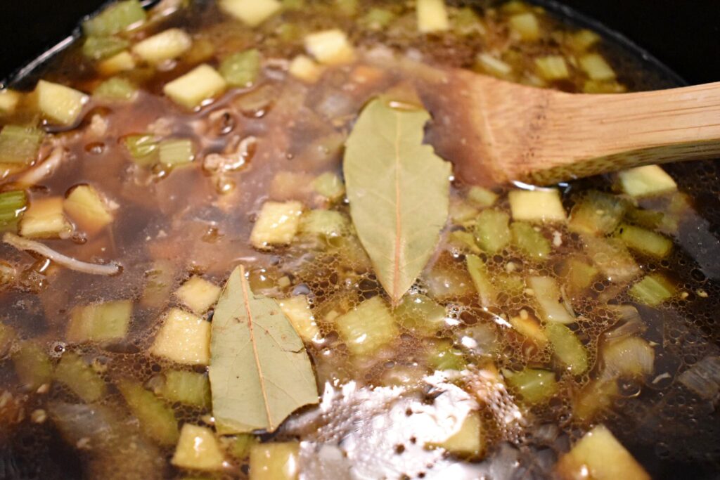 bay leaves resting on top of chicken and sourdough dumplings soup