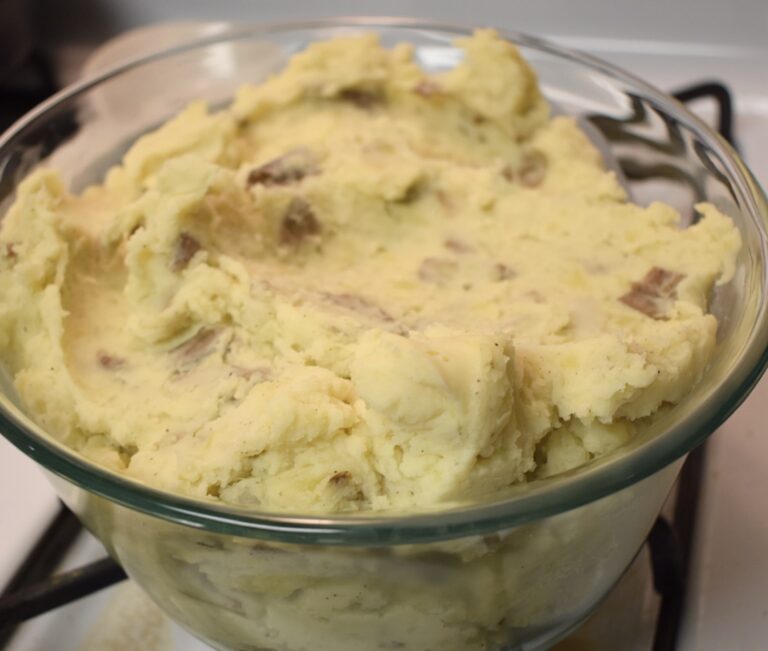 cream cheese mashed potatoes in an oval glass baking dish