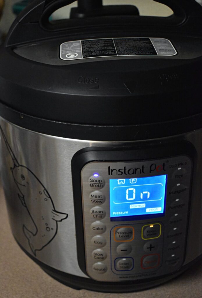 instant pot with soup button pushed, displaying on and high pressure