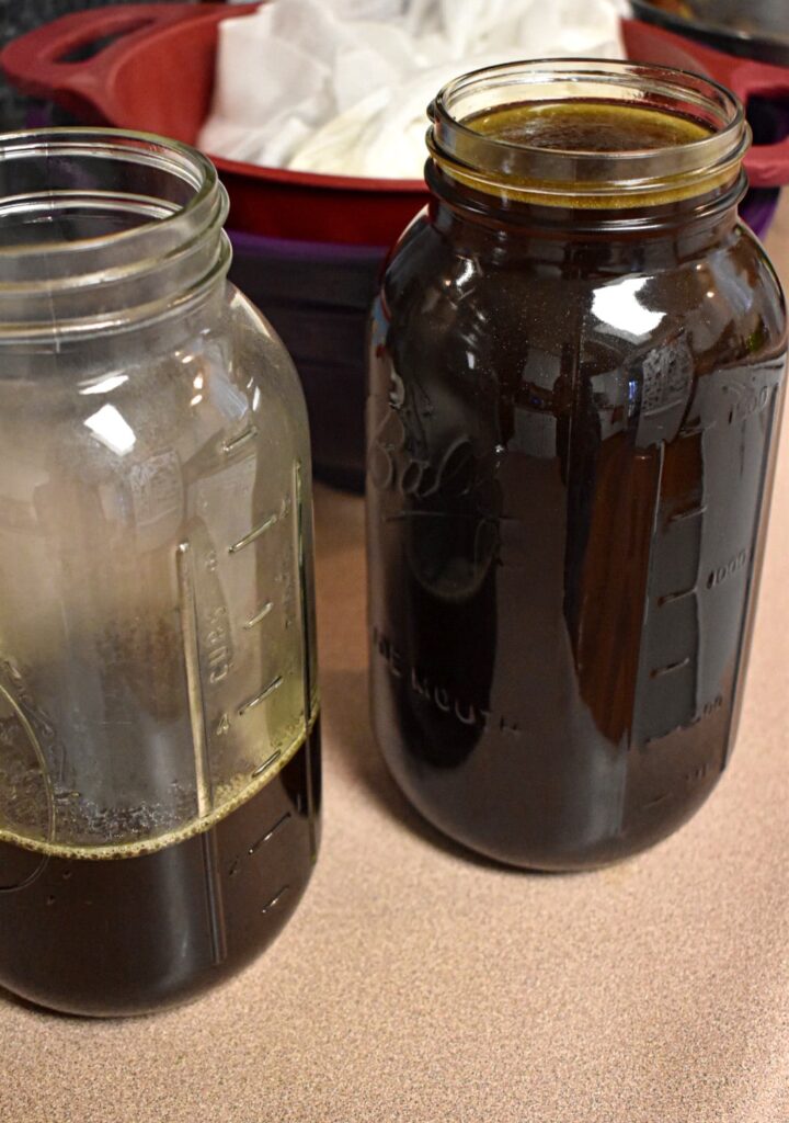 one full half gallon jar of vegetable broth and a half gallon jar with three cups of vegetable broth