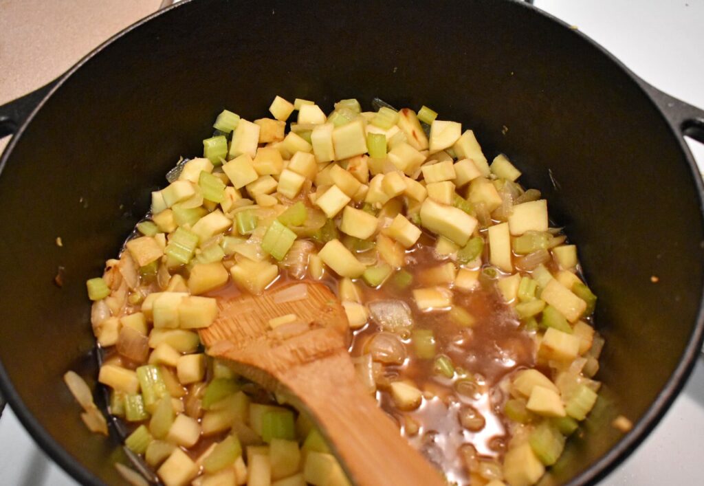 parsnips, onions, celery, and garlic in broth in a cast iron dutch oven
