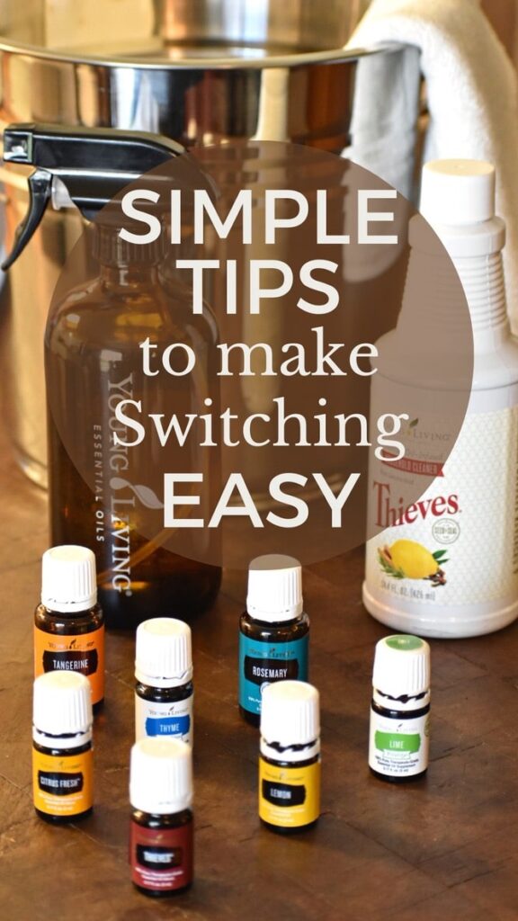 essential oil cleaning supplies on a wooden counter with a metal bucket in the background and the words simple tips to make switching easy
