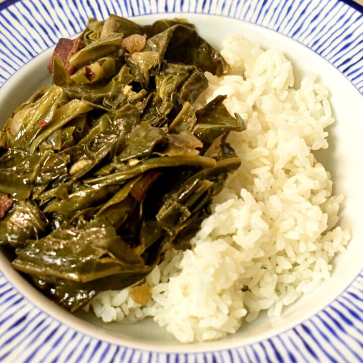 southern collard greens with bacon over rice in a blue and white bowl