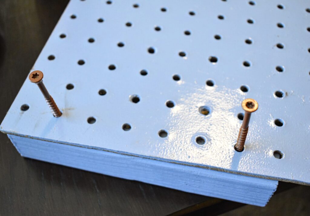 screws partially screwed into a peg board