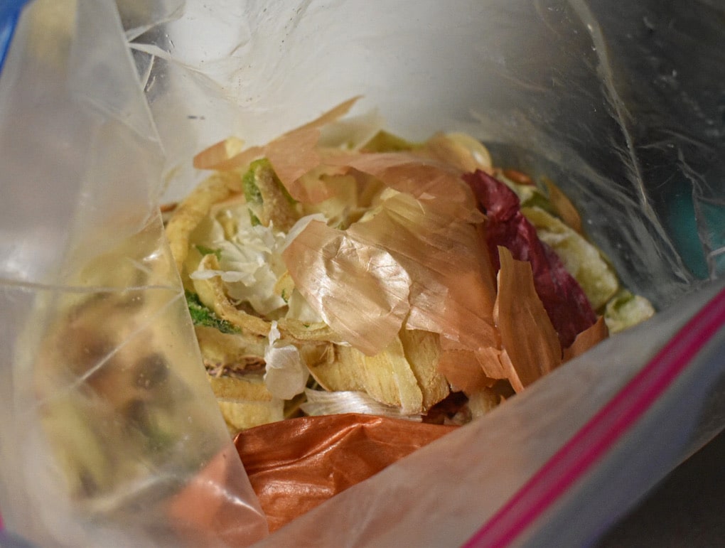 frozen vegetable scraps in a ziplock bag