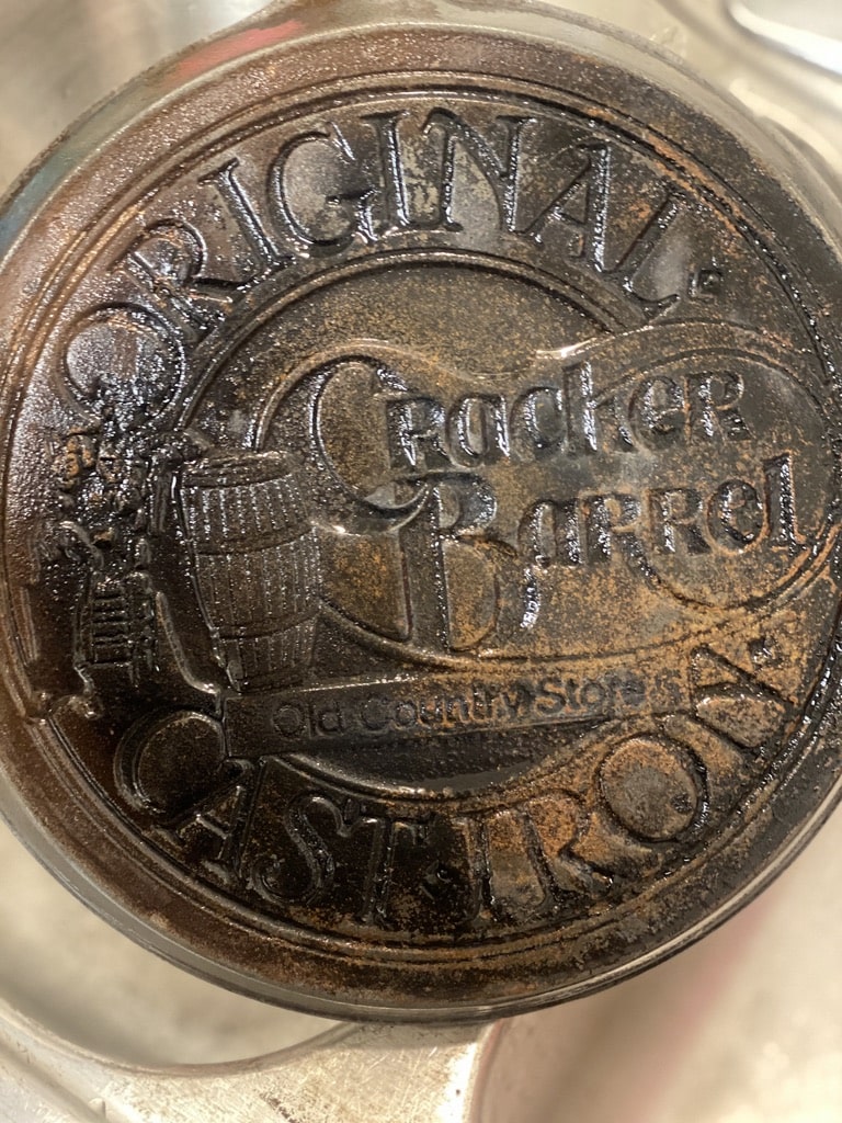 a very dirty and rusty cast iron skillet