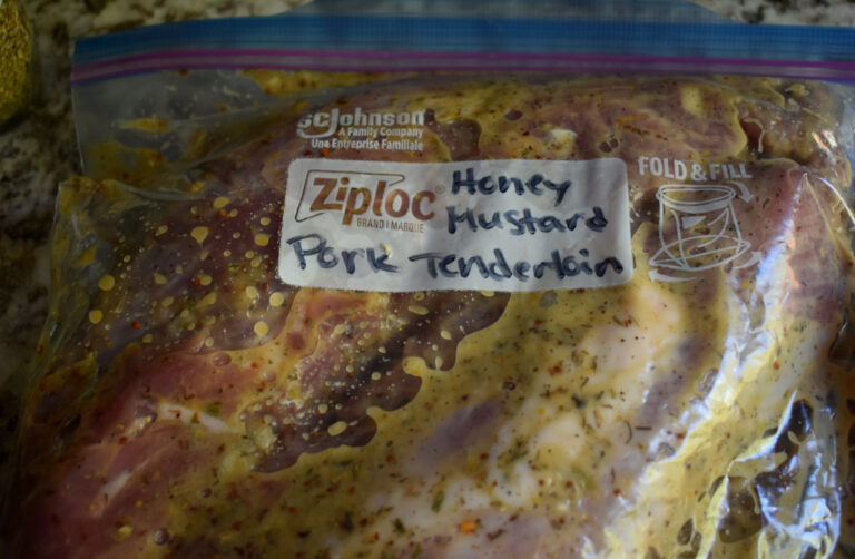 a gallon ziplock labeled honey mustard pork tenderloin full of meat and seasonings